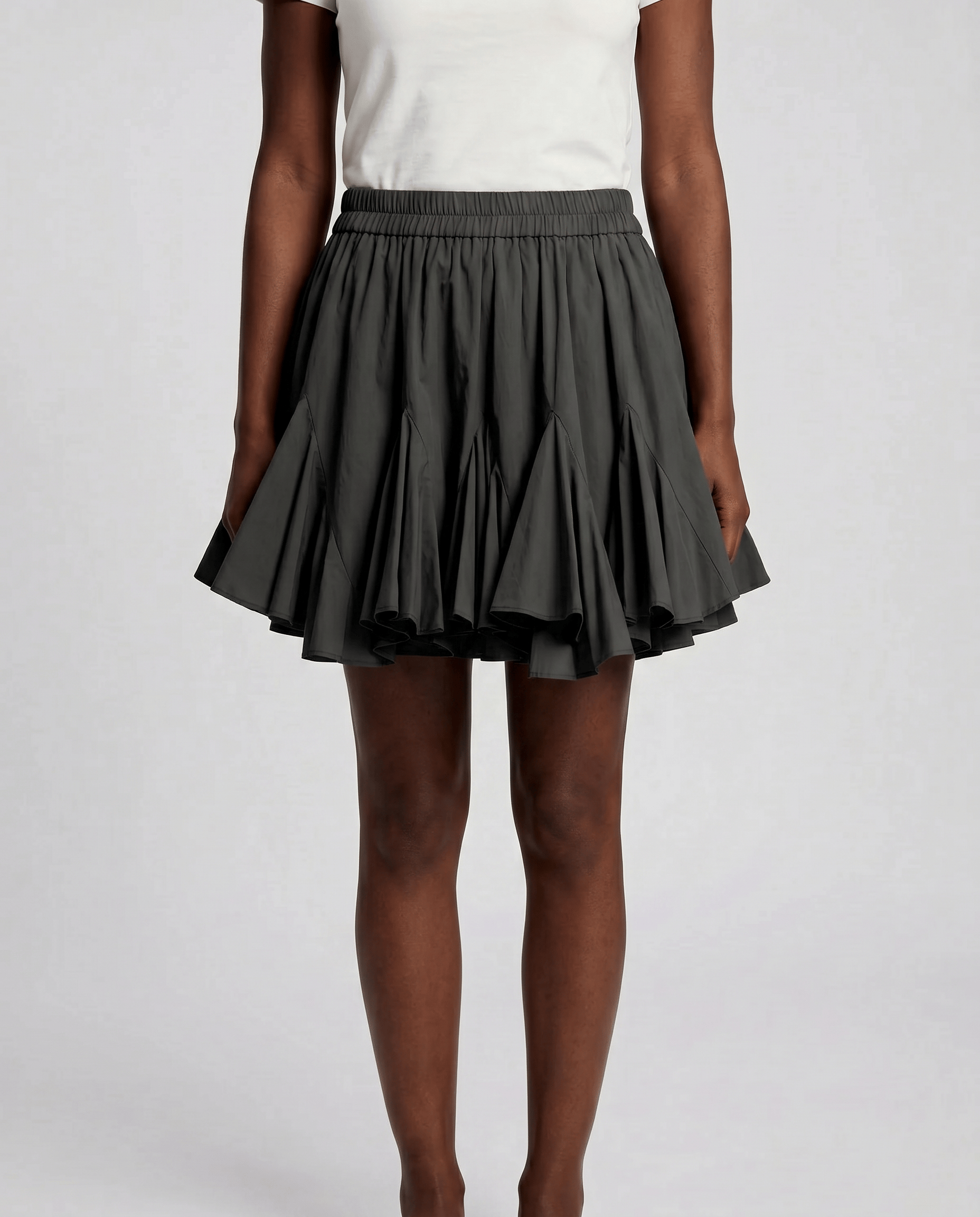 ROMAR pleated ruffle mini skirt in light fabric with a high waist and decorative ruffles, styled on a mannequin.