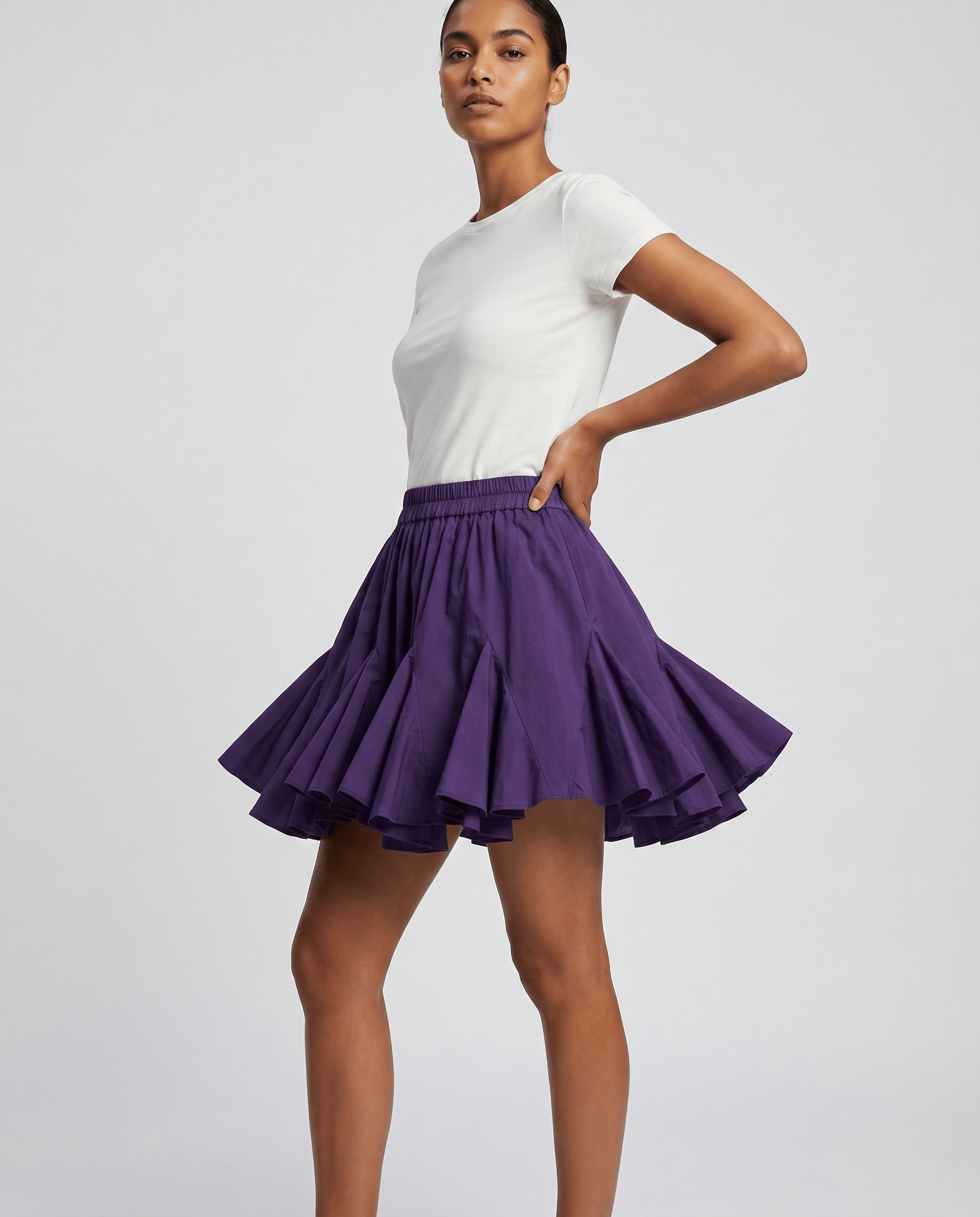 ROMAR pleated ruffle mini skirt with a high waist and flowy design, showcased on a mannequin.