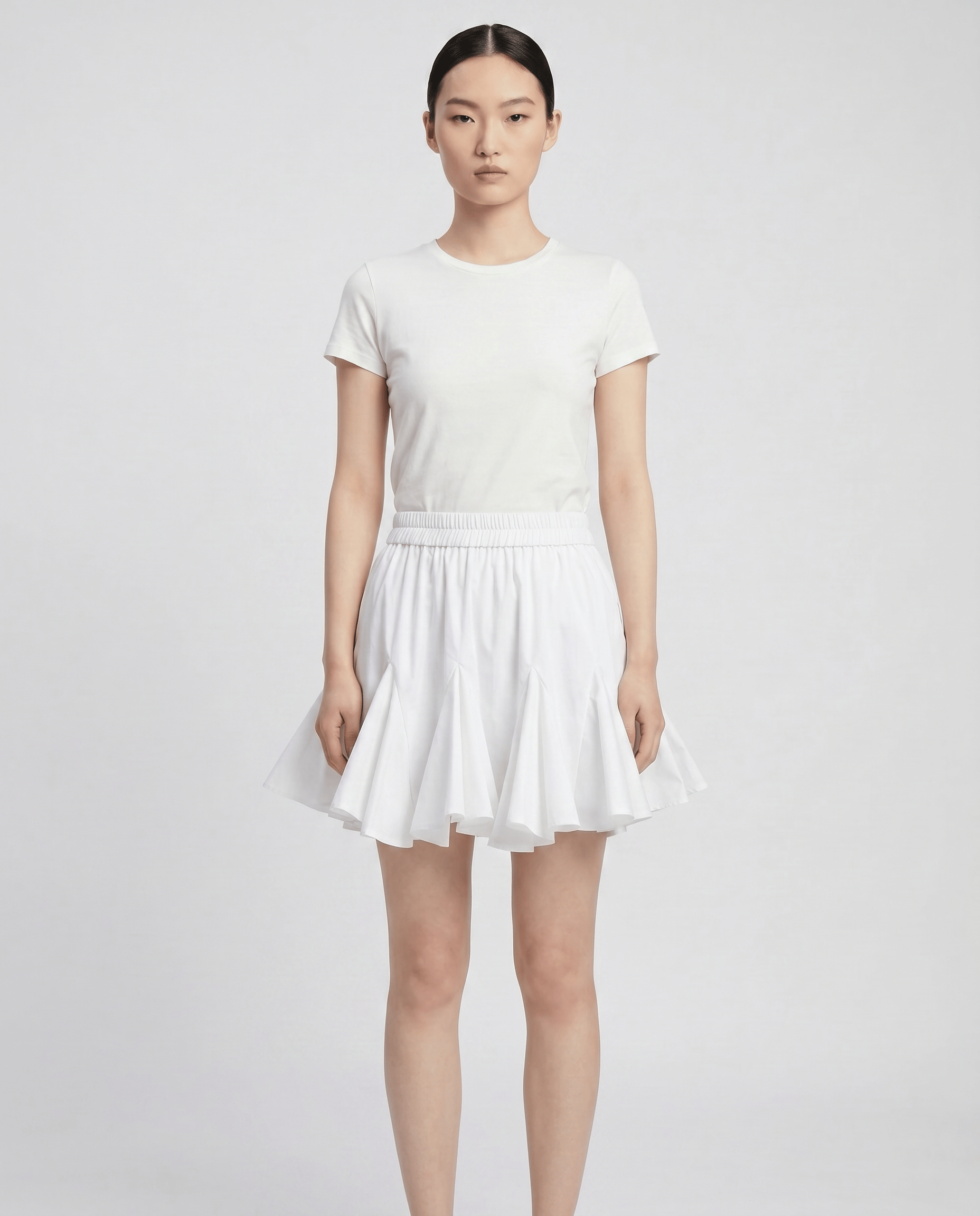 ROMAR pleated ruffle mini skirt in light fabric, showcasing a stylish, flowy design with ruffle details and a high-waist fit.