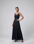 ROMAR glitter scoop neck maxi dress with double straps, flowing fabric, and sparkling finish, perfect for elegant occasions.