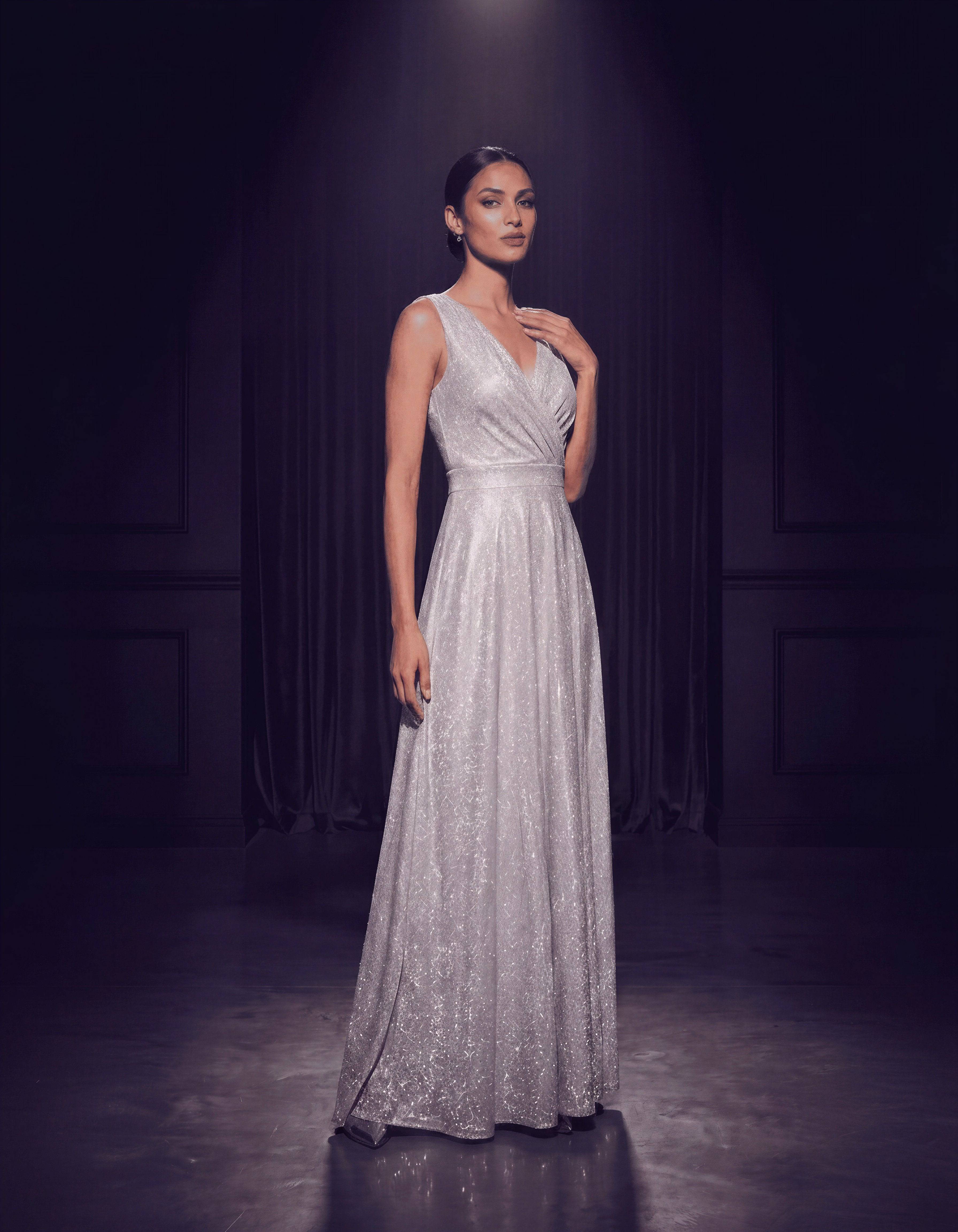 ROMAR glitter V-neck sleeveless prom maxi dress with shimmering fabric and elegant design for formal occasions.