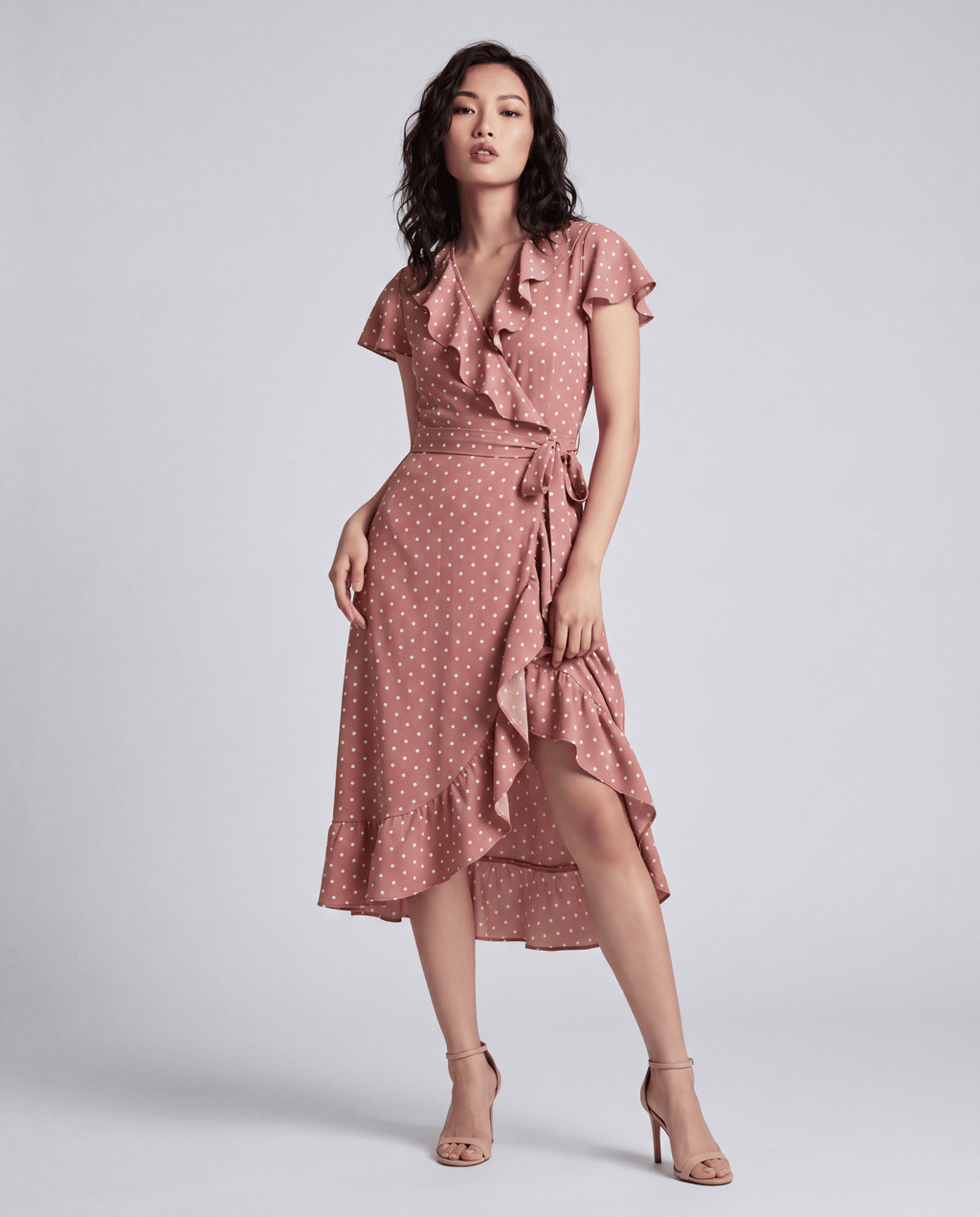 ROMAR printed ruffle wrap midi dress featuring a floral pattern and flowing fabric, styled with ruffled details and a waist tie.