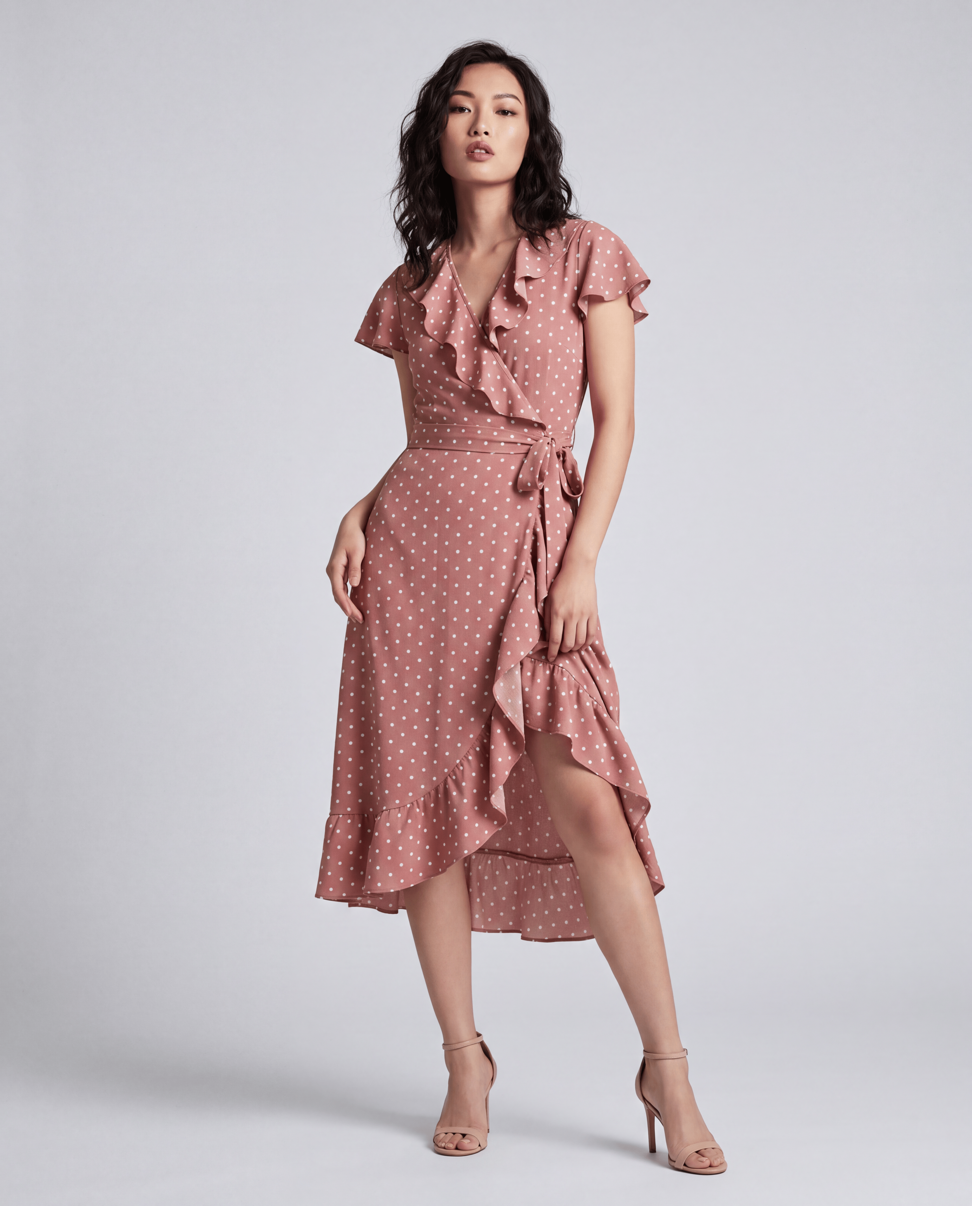 ROMAR printed ruffle wrap midi dress featuring a floral pattern and flowing fabric, styled with ruffled details and a waist tie.