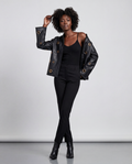 Gold eyelet embellished faux leather jacket by ROMAR, featuring stylish design and metal eyelet details on the jacket front.