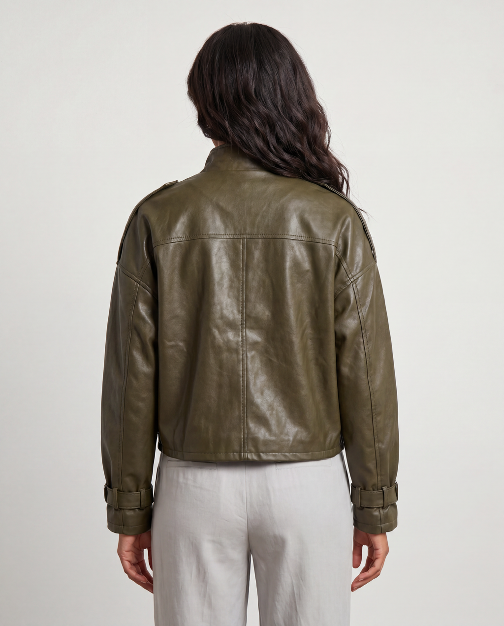 Black faux leather utility bomber jacket by ROMAR with multiple front pockets and ribbed cuffs, styled on a model.