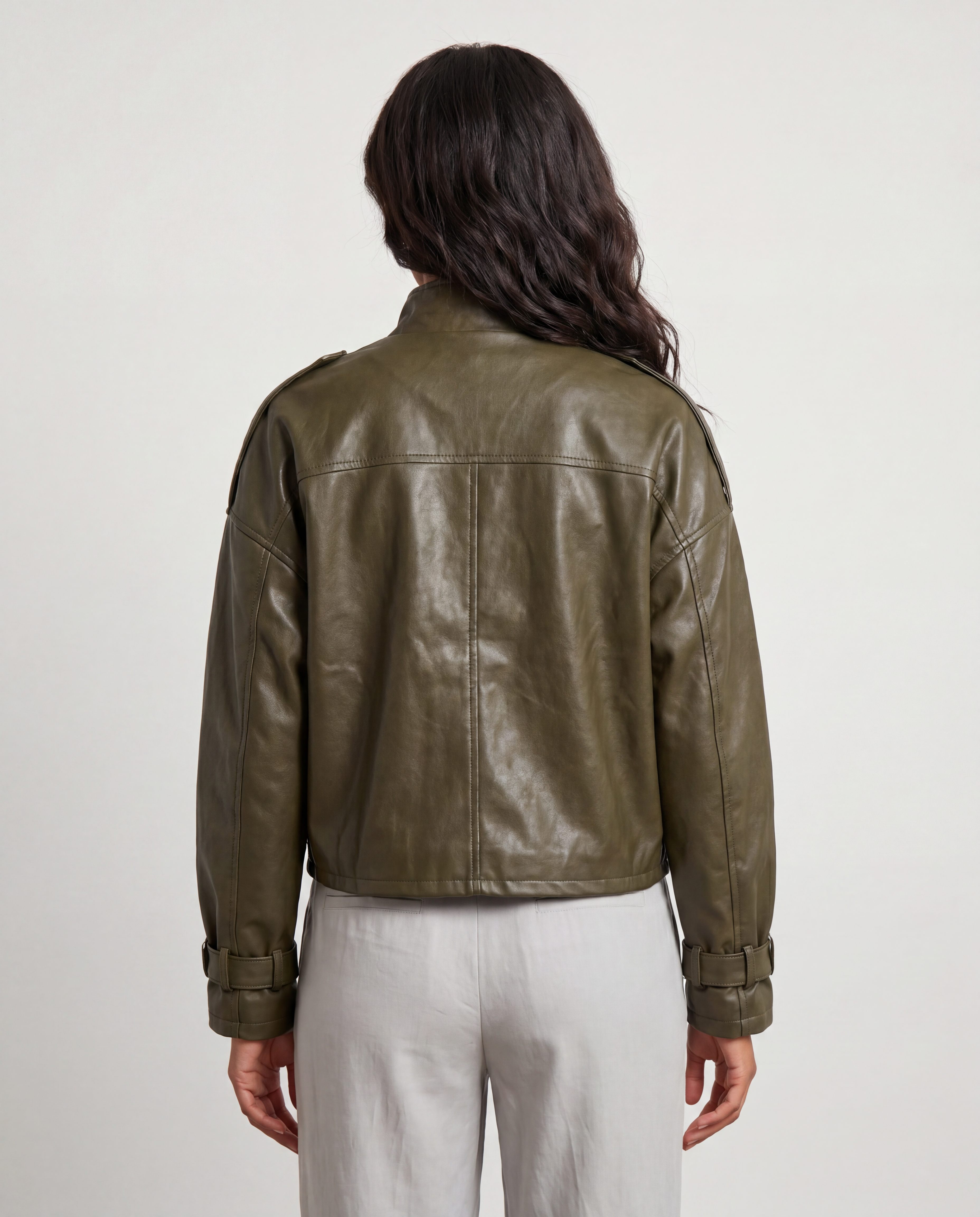 Black faux leather utility bomber jacket by ROMAR with multiple front pockets and ribbed cuffs, styled on a model.
