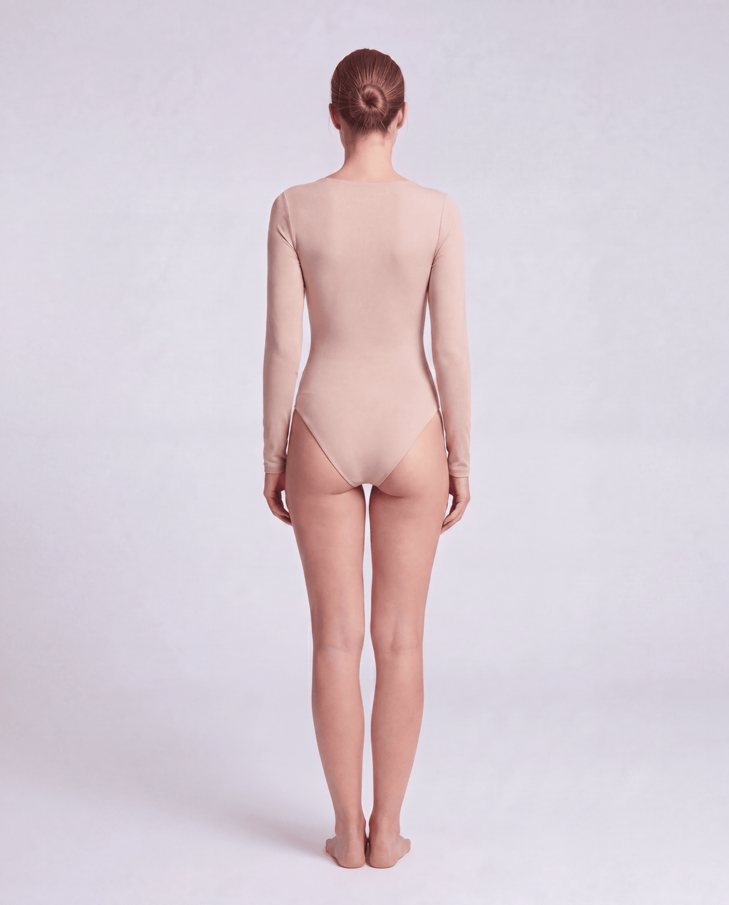 Black V-neck long sleeve bodysuit by ROMAR, fitted style with seamless fabric, shown on a model.