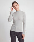 ROMAR ribbed mock neck top with gold button cuffs, showcasing a fitted style and stylish cuff details.