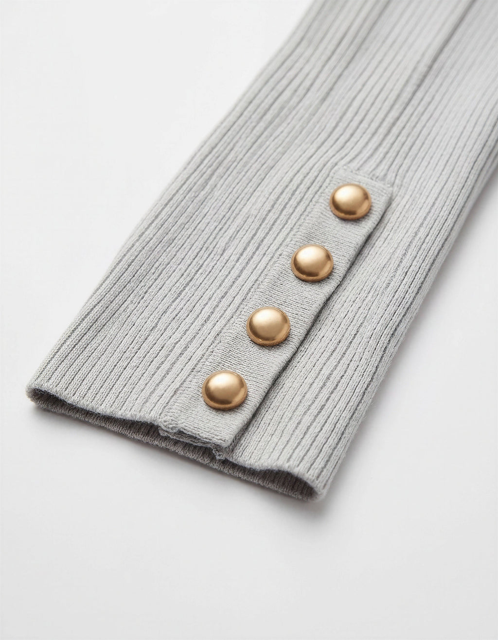 ROMAR ribbed mock neck top with gold button cuffs, close-up of the fitted fabric and stylish cuff details.